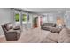 Spacious living area featuring plush seating, large windows, and neutral-toned walls at 9880 E 157Th Ave, Brighton, CO 80602
