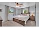 Bedroom featuring a ceiling fan, windows, and a comfortable bed at 9880 E 157Th Ave, Brighton, CO 80602