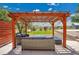 Outdoor patio with comfortable lounge seating under a modern pergola at 9880 E 157Th Ave, Brighton, CO 80602