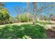 Large backyard with a trampoline and playset offers fun and recreation in a serene, private setting at 5255 Ridge Trl, Littleton, CO 80123