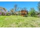 Spacious backyard featuring a well-maintained lawn and a wooden play structure, perfect for outdoor fun at 5255 Ridge Trl, Littleton, CO 80123