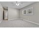 An empty bedroom with light gray walls, carpet, one window with blinds, and white trim at 5255 Ridge Trl, Littleton, CO 80123