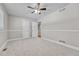 An empty bedroom with light gray walls, carpet, a large closet, and a ceiling fan at 5255 Ridge Trl, Littleton, CO 80123