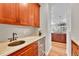 Convenient butler's pantry with custom cabinets, a sink, and a wine cooler, leading into the kitchen at 5255 Ridge Trl, Littleton, CO 80123