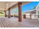 Large backyard deck featuring brick columns, wood flooring and an outdoor seating area at 5255 Ridge Trl, Littleton, CO 80123