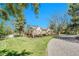 Stunning exterior view of home featuring a wraparound deck, landscaped yard, and a charming gravel driveway at 5255 Ridge Trl, Littleton, CO 80123