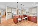 Open-concept kitchen featuring stainless steel appliances, light cabinets, and a sizable island with seating at 5255 Ridge Trl, Littleton, CO 80123