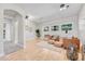 A living room with light wood floors, three large windows and comfortable seating at 5255 Ridge Trl, Littleton, CO 80123