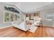 Bright living room featuring a vaulted ceiling, large windows, and built-in shelving at 5255 Ridge Trl, Littleton, CO 80123