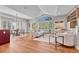 Open-concept living room with vaulted ceilings, large windows, and seamless flow to the dining area at 5255 Ridge Trl, Littleton, CO 80123