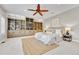 Spacious main bedroom with a ceiling fan, built-in shelving, and plush carpeting at 5255 Ridge Trl, Littleton, CO 80123