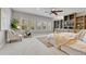 Serene main bedroom with a ceiling fan, built-in shelving, and large windows for natural light at 5255 Ridge Trl, Littleton, CO 80123