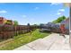 Well-maintained backyard featuring a trampoline and wood fence, perfect for outdoor fun at 19560 E 18Th Pl, Aurora, CO 80011