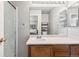 Bathroom features a vanity with sink, updated mirror, and a shower at 19560 E 18Th Pl, Aurora, CO 80011