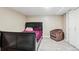 Traditional bedroom features a dark-colored wood bed frame and a brown upholstered chair at 19560 E 18Th Pl, Aurora, CO 80011
