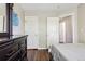 Bedroom with modern decor showcasing a large mirror and two doors at 19560 E 18Th Pl, Aurora, CO 80011