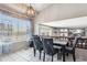 Dining area adjacent to the kitchen, featuring tile floors and a modern chandelier at 19560 E 18Th Pl, Aurora, CO 80011