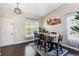Dining room showcasing wood floors, a rustic table, and ample natural light at 19560 E 18Th Pl, Aurora, CO 80011