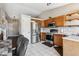 Functional kitchen with oak cabinets, stainless steel appliances, and an efficient layout at 19560 E 18Th Pl, Aurora, CO 80011