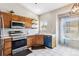 Cozy kitchen features oak cabinets, stainless steel appliances, and tile flooring at 19560 E 18Th Pl, Aurora, CO 80011