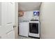 A well-lit laundry room with white washer and dryer at 19560 E 18Th Pl, Aurora, CO 80011