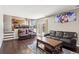 Comfortable living room features hardwood floors, leather seating, and ample natural light at 19560 E 18Th Pl, Aurora, CO 80011