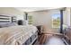 Cozy bedroom features two windows, and hardwood flooring and stylish furnishings at 19560 E 18Th Pl, Aurora, CO 80011