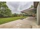 Large backyard featuring a covered patio, lush green lawn, mature trees, and a wood fence for privacy at 10602 W Patterson Pl, Littleton, CO 80127