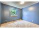 Cozy bedroom with a window overlooking the backyard and neutral carpeting at 10602 W Patterson Pl, Littleton, CO 80127
