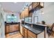 Open kitchen with modern appliances, granite countertops, breakfast bar seating, and hardwood floors throughout at 10602 W Patterson Pl, Littleton, CO 80127