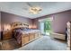 Spacious primary bedroom featuring a ceiling fan, a large window, and neutral colored walls at 10602 W Patterson Pl, Littleton, CO 80127