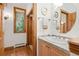 Bright bathroom features hardwood floors, a granite countertop vanity, and a framed window at 2164 Foothills S Dr, Golden, CO 80401