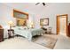 Cozy bedroom features neutral carpet, a framed window and an attached bathroom at 2164 Foothills S Dr, Golden, CO 80401