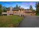 A charming home featuring a spacious driveway, manicured lawn, and an attached two-car garage at 2164 Foothills S Dr, Golden, CO 80401