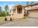 Inviting home featuring a covered entryway with a spacious front yard and attached two-car garage at 2164 Foothills S Dr, Golden, CO 80401