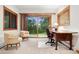 Home office with large sliding glass doors to the backyard and mature trees at 2164 Foothills S Dr, Golden, CO 80401