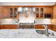 Well-equipped kitchen features custom cabinetry, stainless steel appliances, and granite countertops at 2164 Foothills S Dr, Golden, CO 80401