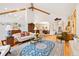Expansive living room showcasing high ceilings, hardwood floors, and an open layout connecting to the dining area at 2164 Foothills S Dr, Golden, CO 80401