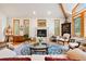 Bright living room features hardwood floors, a marble fireplace, and several windows with neighborhood views at 2164 Foothills S Dr, Golden, CO 80401