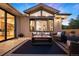 Comfortable outdoor patio featuring ample seating, a coffee table, and views of the surrounding neighborhood at 2164 Foothills S Dr, Golden, CO 80401