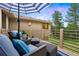 Comfortable outdoor patio area with cushioned seating and umbrella at 2164 Foothills S Dr, Golden, CO 80401
