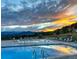 Community pool with mountain views at sunset, featuring ample lounge seating and a serene atmosphere at 2164 Foothills S Dr, Golden, CO 80401
