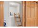 Unique storage area accessible by a wooden ladder and enclosed by a sliding door at 2164 Foothills S Dr, Golden, CO 80401