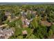 An aerial view showing a home with a well-manicured lawn and mature trees at 560 Front Range Rd, Littleton, CO 80120