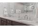 Bright bathroom boasts double sinks, modern fixtures, and white tile in shower at 560 Front Range Rd, Littleton, CO 80120