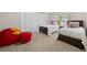 Fun bedroom with twin beds, stuffed animals, and cozy seating area at 560 Front Range Rd, Littleton, CO 80120