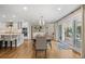 Open-concept living space with a dining area that connects to a stylish kitchen and outdoor living space at 560 Front Range Rd, Littleton, CO 80120