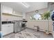 Well-lit laundry room offers modern machines, storage cabinets, and backyard views at 560 Front Range Rd, Littleton, CO 80120