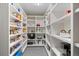 Walk-in pantry featuring ample shelving space for organized kitchen storage at 560 Front Range Rd, Littleton, CO 80120