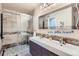Spa-like bathroom with walk-in shower and double vanity at 4508 E Louisiana Ave, Denver, CO 80246